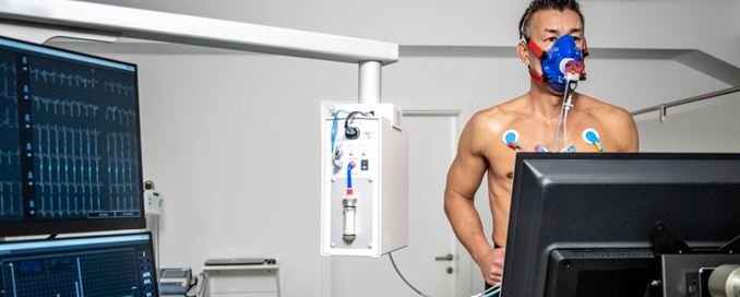 Patient running on treadmill with heart and oxygen monitors